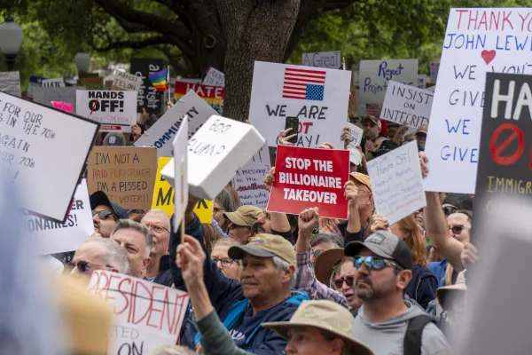 Stop the Billionaire Takeover Sign at a rally in Austin