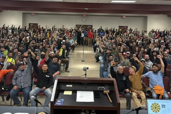IBEW Local 20 members raise their fists in solidarity for a group picture