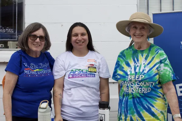 Three volunteer deputy voter registrars pose for a photo