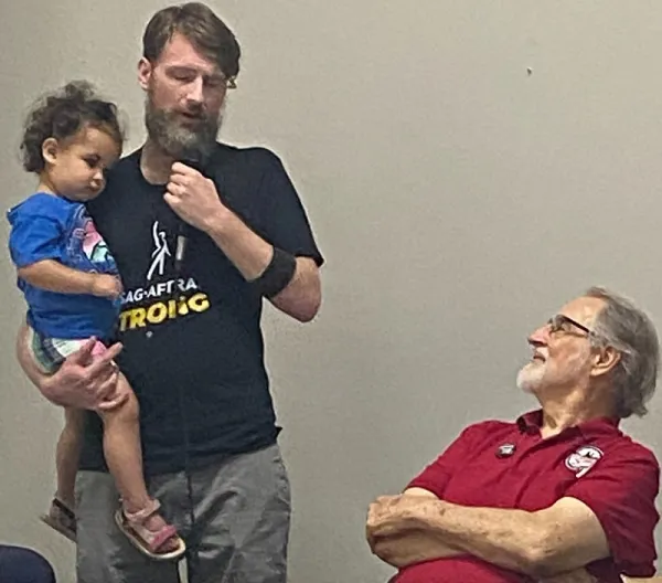 Holding his baby, SAG-AFTRA leader addresses Dallas AFL-CIO