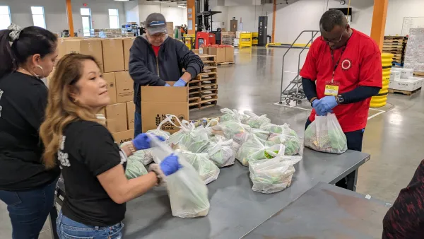 Lee Forbes helps pack food sacks